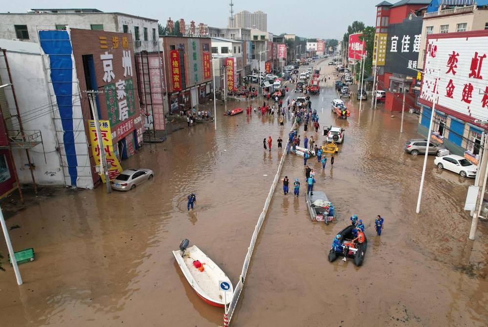 Pemandangan dari udara menunjukkan pasukan penyelamat melakukan kerja-kerja menyelamat di Zhuozhou, bandar Baoding, di utara China pada Rabu. - Foto AFP