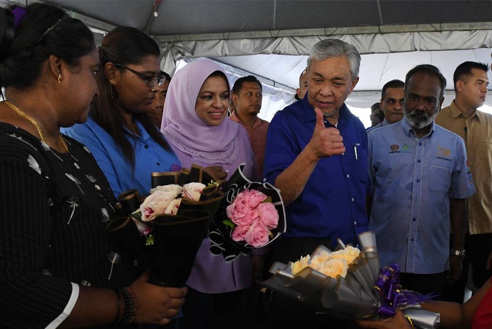 Ahmad Zahid beramah mesra dengan masyarakat yang mengubah bunga pada karnival kerjaya MyFuture Jobs Bersama Hawa Malaysia, pada Sabtu. - Foto Bernama