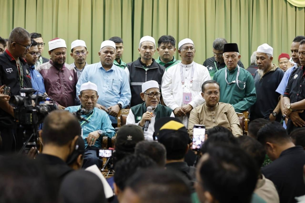 Presiden Pas, Tan Sri Abdul Hadi (tengah) bersama Naib Presiden Pas, Datuk Seri Dr Ahmad Samsuri Mokhtar (duduk, kanan) dan Pesuruhjaya Pas Terengganu, Datuk Husain Awang ketika sidang akhbar selepas mengumumkan kemenangan Perikatan Nasional (PN) di Dewan Tok Guru, Masjid Rusila, Marang. 