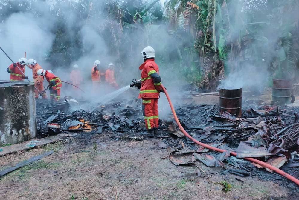 Anggota bomba memadamkan kebakaran yang mengakibatkan seorang warga emas rentung dalam kejadian di Kampung Sungai Pilah, Bukit Gambir, tangkak, pada Ahad