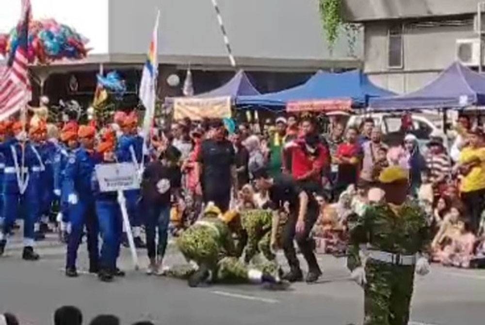 Tangkap layar video yang memaparkan seorang anggota Rela rebah ketika perbarisan berkenaan pada Khamis.