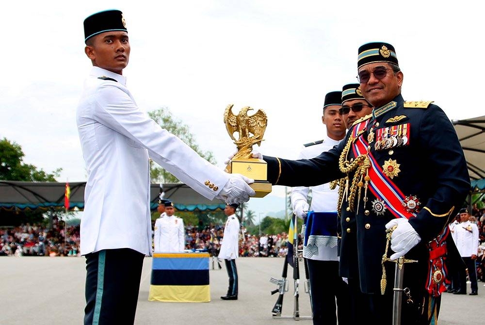 Mohd Asghar Khan (kanan) menyampaikan Anugerah Perajurit Terbaik Keseluruhan kepada Muhammad Azmin Hakimi (kiri) pada Perbarisan Tamat Latihan Perajurit Muda Tentera Udara Diraja Malaysia (TUDM) Siri 66/2023 di Akademi Tentera Udara Ipoh hari ini. Foto Bernama