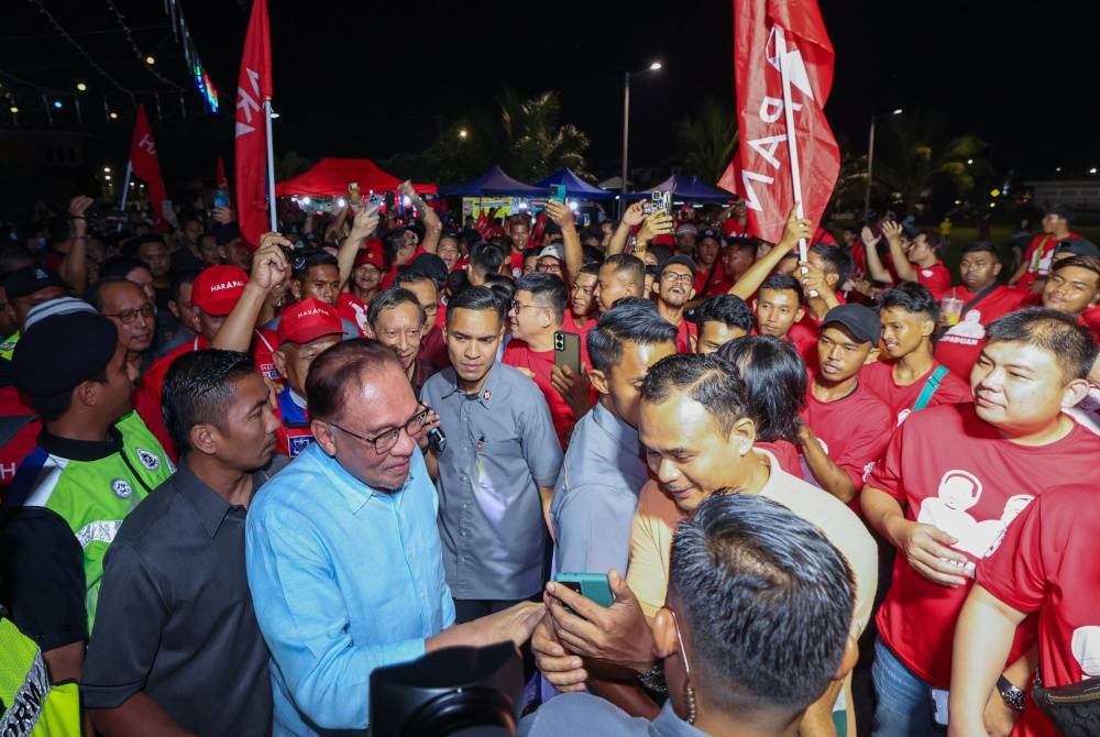 Perdana Menteri Datuk Seri Anwar Ibrahim bersalaman dengan para penduduk ketika hadir pada Ceramah Mega Perpaduan Madani DUN Simpang Jeram di Taman Desa, Sungai Abong baru-baru ini. - Foto Bernama