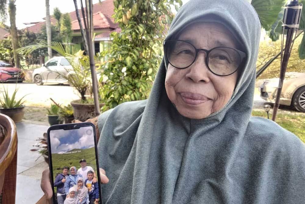 Aminah menunjukkan gambar Allahyarham Mohd Hasmawi yang menjadi kenangan mereka sekeluarga.