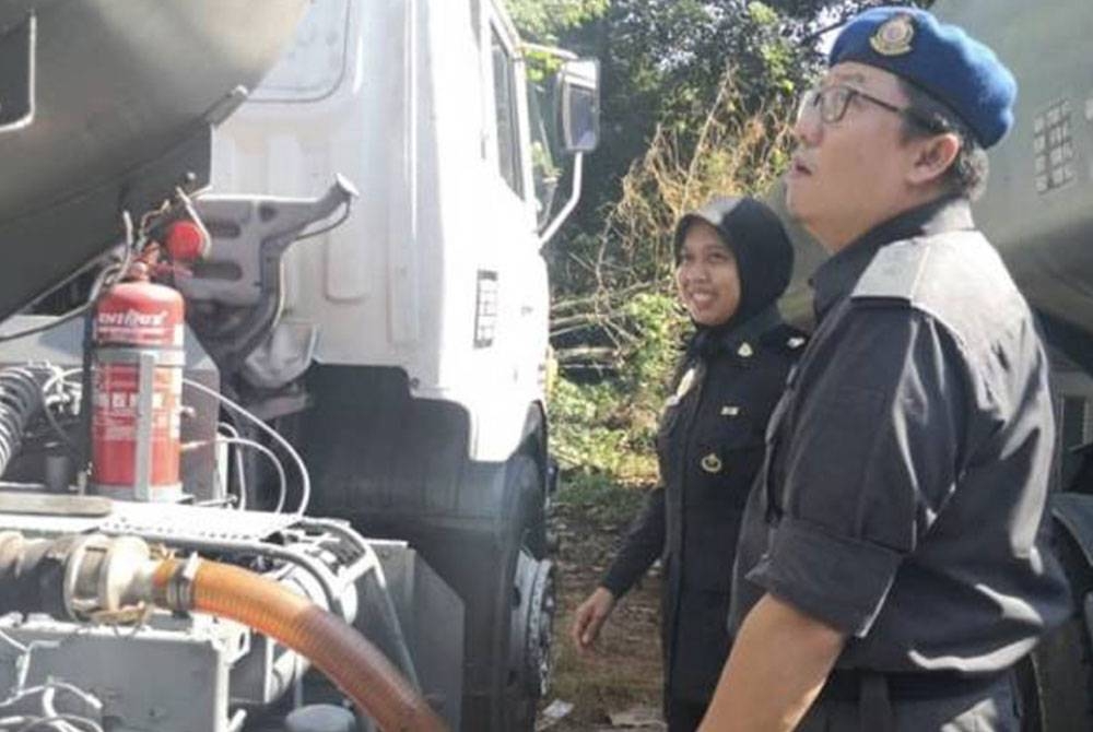 Kamalludin melakukan pemeriksaan ke atas lori tangki yang telah diubahsuai tangki asal kenderaan. - Foto KPDN Perak