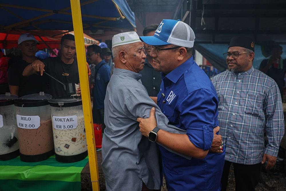 Amizar beramah mesra bersama pengunjung sempena kempen PRK DUN Pelangai di tapak pasar malam Felda Chemomoi pada Ahad. - Foto Bernama