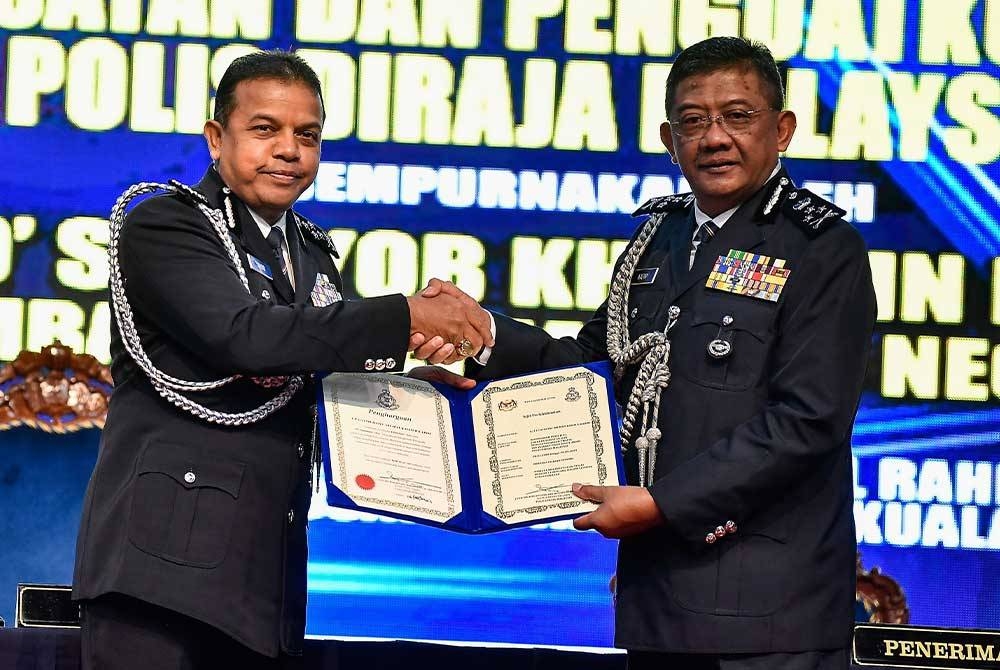 Ayob Khan (kiri) menyerahkan Sijil Penghargaan dan Perkhidmatan kepada Mat Kasim selepas majlis serah terima tugas jawatan di Dewan Tan Sri Abdul Rahman Hashim, Pulapol pada Jumaat. - Foto Bernama