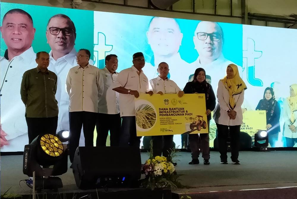 Saarani (tiga dari kanan) menyampaikan replika dana bantuan infrastruktur dan pembangunan padi selepas merasmikan Penutupan Perak Agrofest 2023 di Ladang Infoternak Sungai Siput (U) di sini pada Ahad.