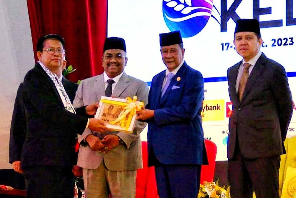 Sultan Kedah, Sultan Sallehuddin Sultan Badlishah (dua kanan) menyerahkan cenderamata kepada peserta forum pada Persidangan Antarabangsa Ke-12 Forum Zakat dan Wakaf 2023 pada Rabu.