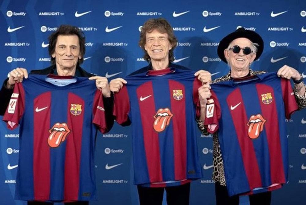 Anggota Rolling Stones, (dari, kiri) Ronnie Wood, Mick Jagger dan Keith Richards sambil memegang jersi Barcelona dengan lidah ikonik, selepas kelab Catalan itu mengumumkan akan memakai jersi tersebut dalam perlawanan Clasico menentang Real Madrid pada 28 Oktober. - Foto AGENSI