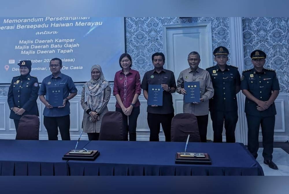 Sandrea (empat dari kiri) bersama Ahmad Suqairy (empat dari kanan), Ahmad Roslan (tiga dari kanan) dan Mohamad Razif (dua dari kiri) yang selesai menandatangani MoU Operasi Bersepadu Haiwan Merayau dalam satu majlis di Kampar pada Selasa.