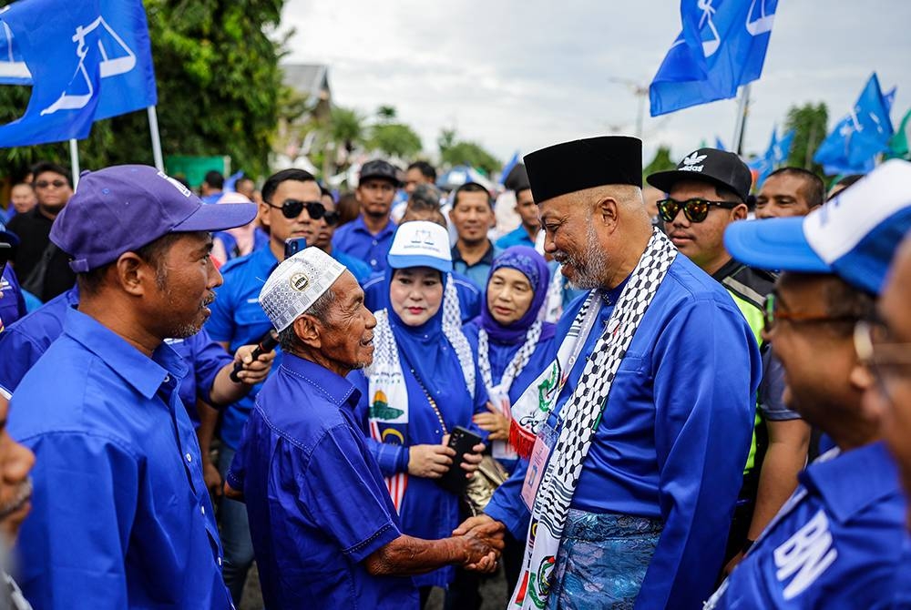 Raja Mohamed Affandi beramah mesra bersama penyokong BN di Pusat Penamaan Calon Pilihan Raya Kecil (PRK) Parlimen Kemaman di Dewan Berlian Utama, Majlis Perbandaran Kemaman, hari ini. - Foto Bernama