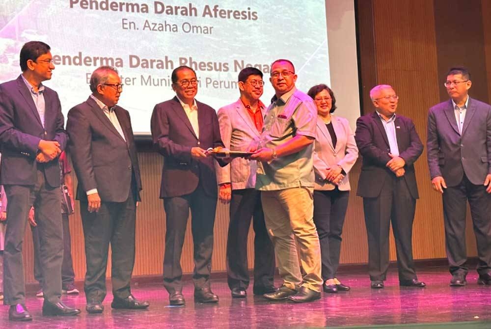 Azaha (empat dari kanan) menerima sijil yang disampaikan oleh Mohamed Khaled Nordin (tiga dari kiri).