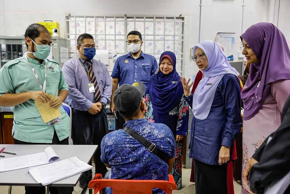 Dr Zaliha (dua dari kanan) bertanyakan keadaan seorang pesakit di Klinik Kesihatan Air Puteh ketika beliau melakukan lawatan kerja ke klinik tersebut pada Isnin. - Foto: Bernama