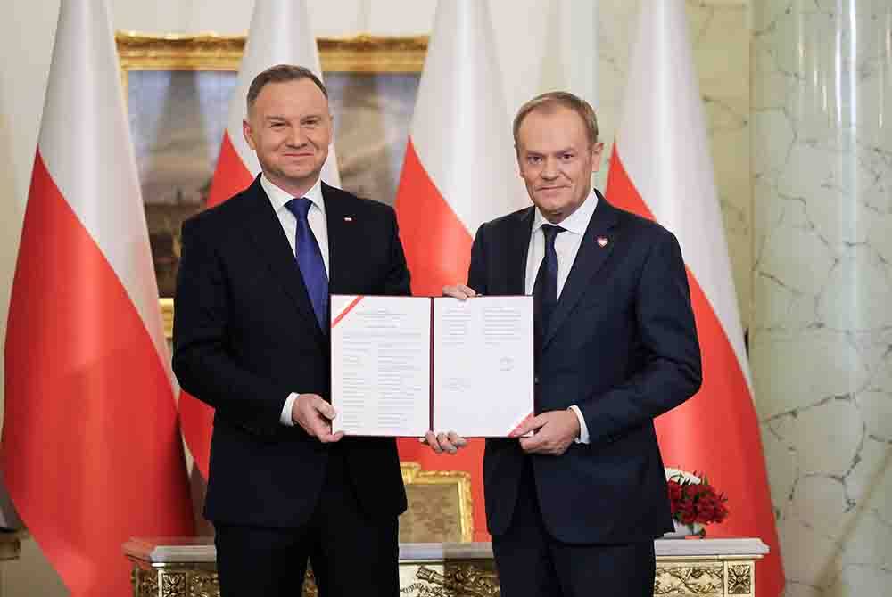 Presiden Poland, Andrzej Duda (kiri) melantik Donald Tusk (kanan) sebagai Perdana Menteri Poland dalam kerajaan baharu semasa majlis di Istana Presiden di Warsaw. - Foto EPA