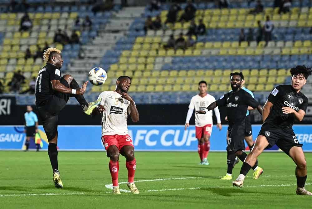 Pemain Terengganu, FC Sony Norde (kiri) diasak pemain Bali United FC, Jean Marie Mbarga (dua, kiri) pada perlawanan Piala AFC di Stadium Sultan Mizan Zainal Abidin malam Rabu. - Foto Bernama