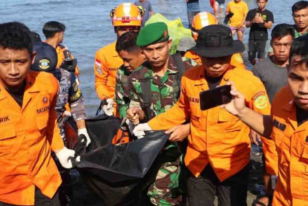 Pasukan SAR mengangkat mayat mangsa selepas bot yang membawa 28 tetamu majlis perkahwinan itu karam di perairan Pulau Ambo di wilayah timur Indonesia. - Foto ANTARA