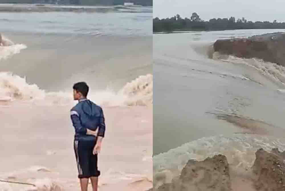 Penduduk melihat benteng PLSB yang pecah.