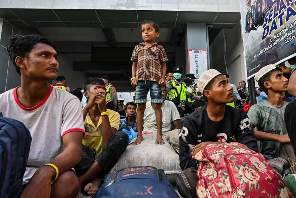 Pelarian Rohingya berkumpul di hadapan bangunan kerajaan selepas mereka dipaksa berpindah dari kemudahan kerajaan sebelum ini di Banda Aceh pada 27 Disember lalu - Foto: AFP