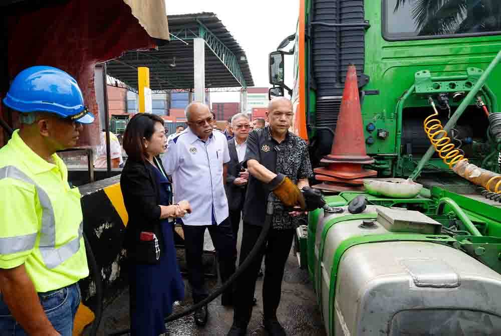 Menteri Perdagangan Dalam Negeri dan Kos Sara Hidup, Datuk Armizan Mohd Ali (kanan) mengisi minyak diesel ke dalam tangki lori ketika membuat lawatan ke tapak Skid Tank sempena lawatan kerja ke syarikat barangan dan sidang media berkenaan pelaksanaan projek rintis Sistem Kuota Diesel Subsidi 2.0 (SKDS 2.0) di Syarikat Perceptive Logistics Sdn Bhd, Kawasan Perindustrian Bandar Sultan Suleiman, pada Selasa. Turut hadir, Pengurus Besar Perceptive Logistics Sdn Bhd, Annie Goh (dua, kiri). Foto Bernama