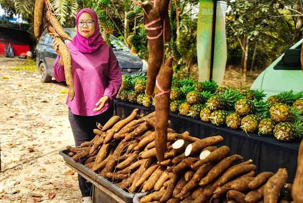 Rozana bersama ubi kayu yang dijual di Paya Pulai, Temerloh.