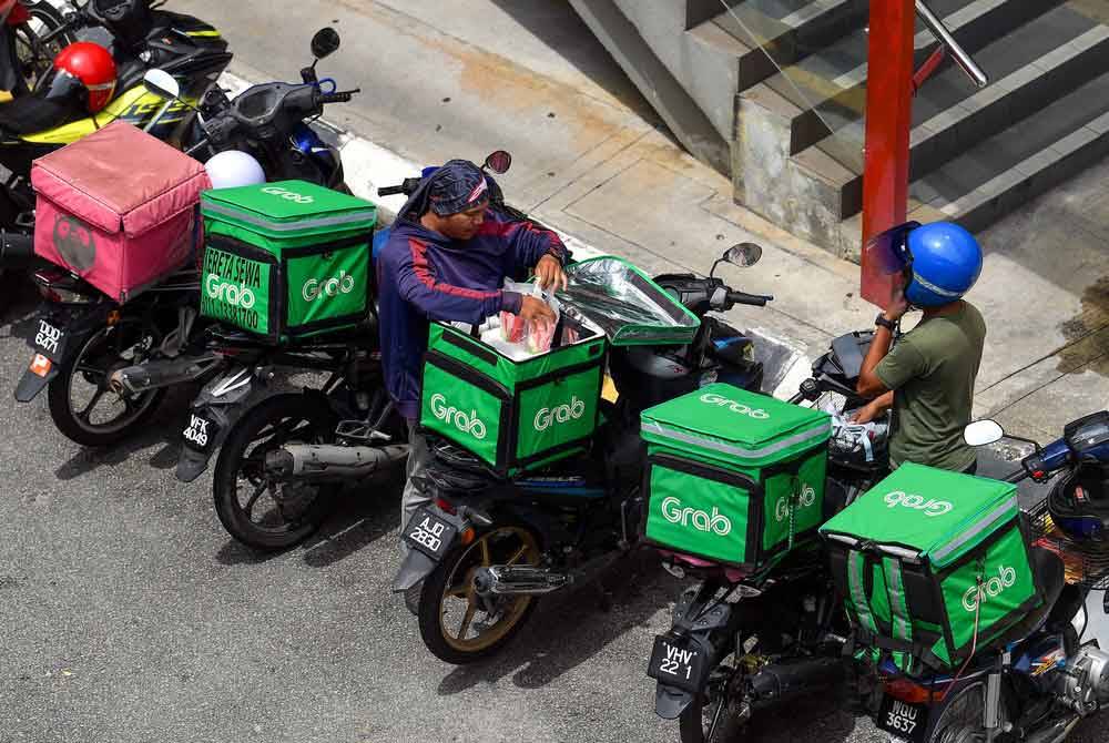 Penunggang GrabFood sebelum ini dilaporkan mendakwa kadar upah penghantaran kepada mereka diturunkan lagi daripada RM4.30 ke RM3.50. -Foto: Bernama