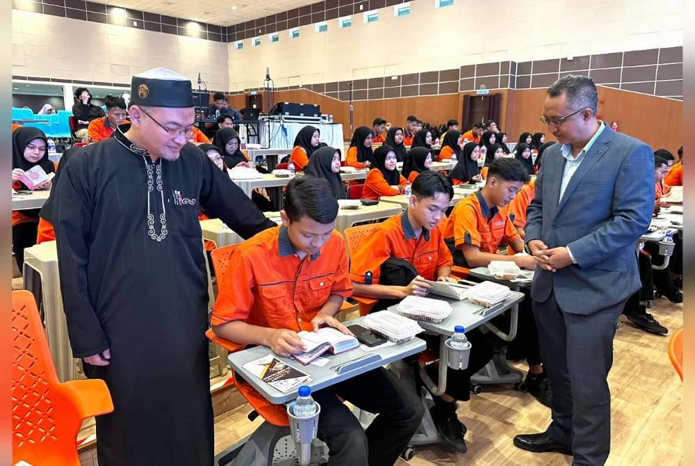 Ahmad (kiri) dan Mohammad (kanan) melihat penuntut dari Kolej Vokasional Bachok yang menyertai Tadabbur Tour di UMK.