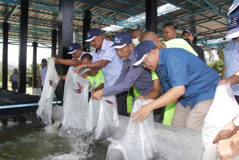 
Bakri (tiga, kanan) melepaskan anak ikan dalam satu program di Jelebu baru-baru ini.