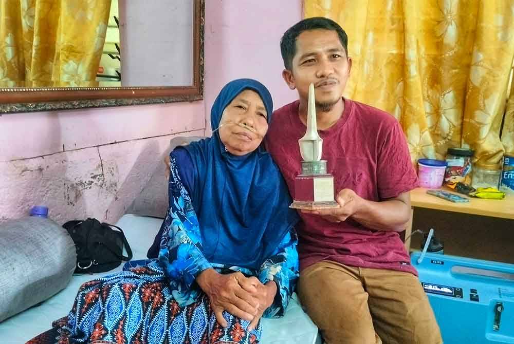 Abdul Khalid bersama ibunya, Raja Maharani dengan anugerah yang pernah dimenangi oleh Allahyarham Abdul Kadir.