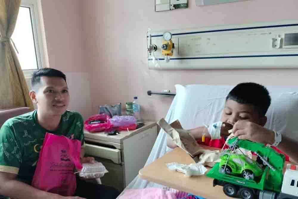 Nor Ezwan Budiman menemani Nor Iman Firdaus yang berhadapan masalah autisme selepas berjaya dikhatankan melalui program Sunathon di Hospital Enche Besar Hajjah Khalsom (HEBHK), Kluang pada Khamis