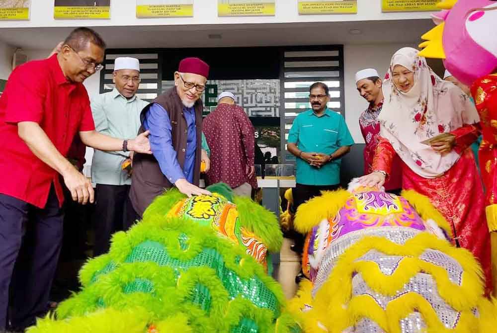 Abdul Hadi berpeluang memberi angpau kepada pasukan tarian singa semasa sambutan Tahun Baharu Cina di Pejabat Agung Pas di Kuala Lumpur.