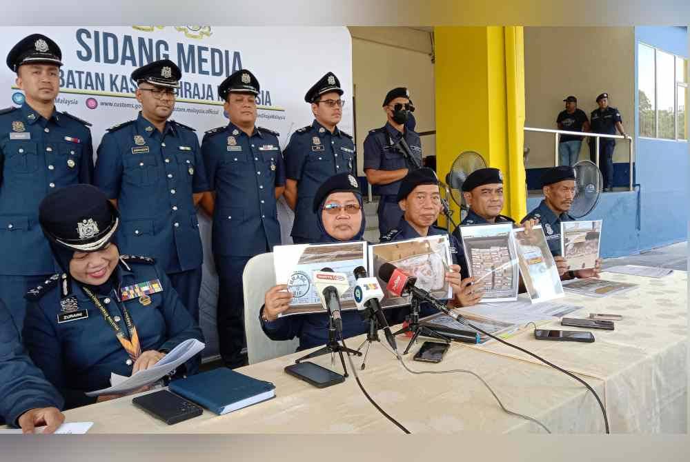 Norlela (tengah) menunjukkan gambar daging babi yang dirampas menerusi siri serbuan dan operasi dijalankan sebelum ini.