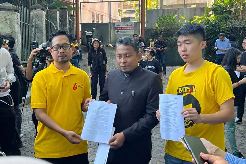 Ahmad Fadhli (tengah) menerima memorandum tuntutan reformasi daripada Pengerusi Bersih, Muhammad Faisal Abdul Aziz (kiri) ketika perhimpunan Reformasi 100 peratus di Kuala Lumpur pada Selasa.