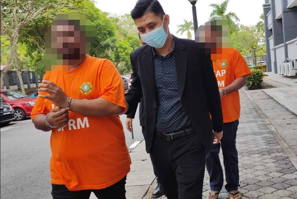 Kedua-dua suspek diiring pegawai SPRM ketika permohonan reman di Mahkamah Seremban