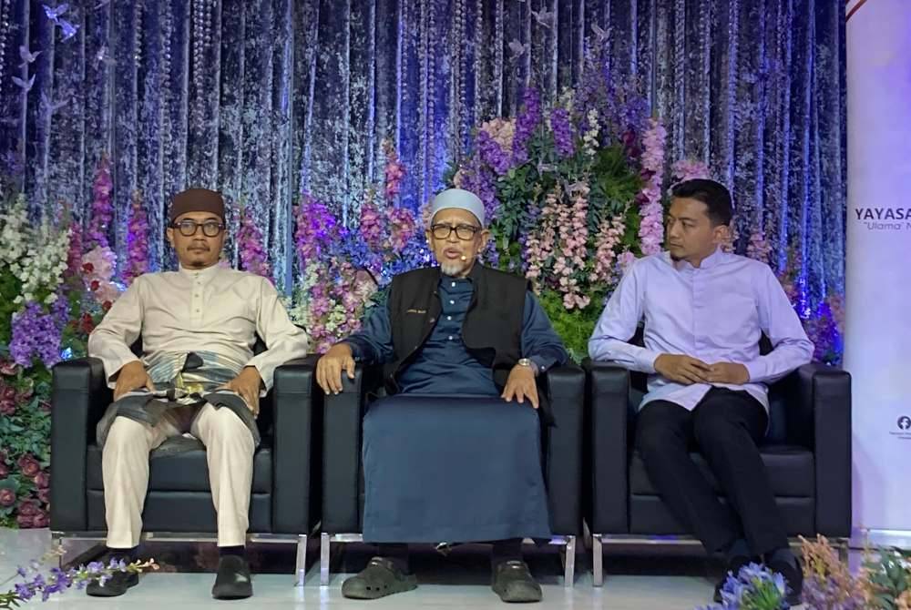 Abdul Hadi (tengah) ditemani Ahli Jawatankuasa Kerja Pas Pusat, Dr Muhammad Khalil Abdul Hadi (kiri) dan Penolong Setiausaha Agung Pas, Mohd Syahir Che Sulaiman (kanan) ketika memberi ucapan di Program Iftar Yayasan Permata Ummah di Bizmilla Event Hall, di sini pada Sabtu.