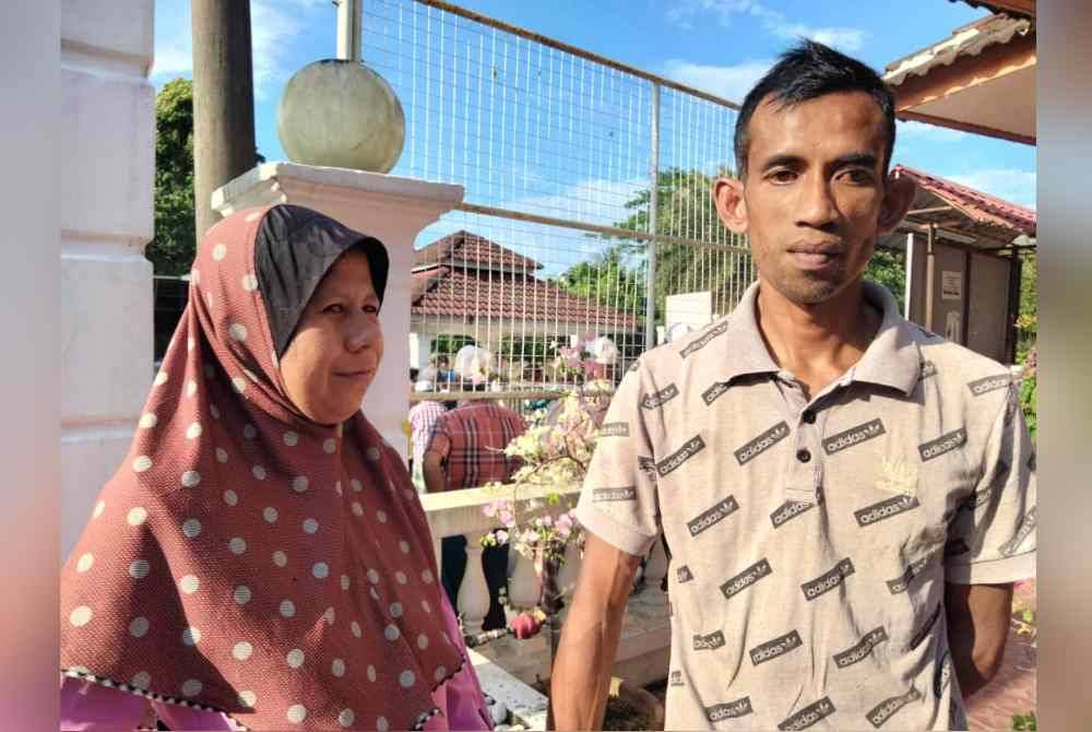 Mohd Razi (kanan) dibantu isterinya, Nastasya Farahanin menerima sumbangan pada Program Ramadan Relief Serantau bersama Maybank Islamic anjuran AIM di Masjid Mukim Kubang Panjang.