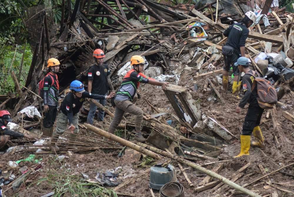 Anggota Badan Mencari dan Menyelamat Nasional (BASARNAS) mencari mangsa yang terselamat di lokasi kejadian tanah runtuh di Cipongkor, wilayah Jawa Barat pada Isnin. Foto AFP