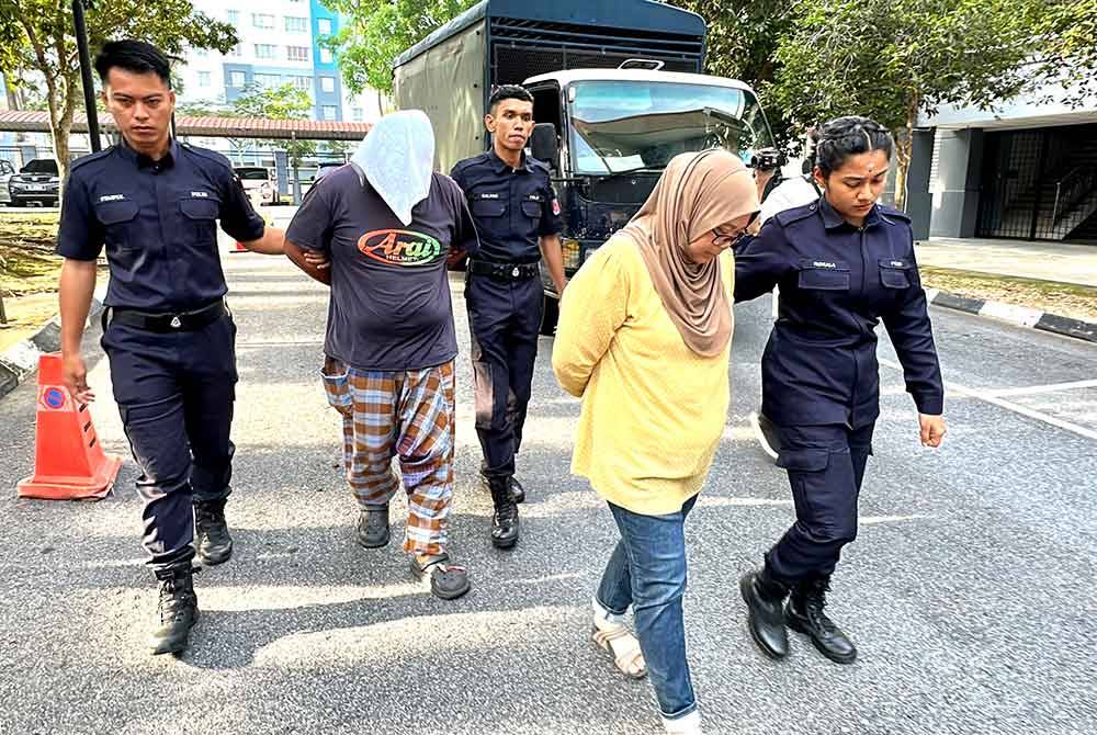 Tertuduh diiringi polis ketika hadir ke mahkamah atas pertuduhan mengabaikan anak kandung perempuan berusia tiga tahun sehingga mengakibatkan kematiannya bulan lalu.