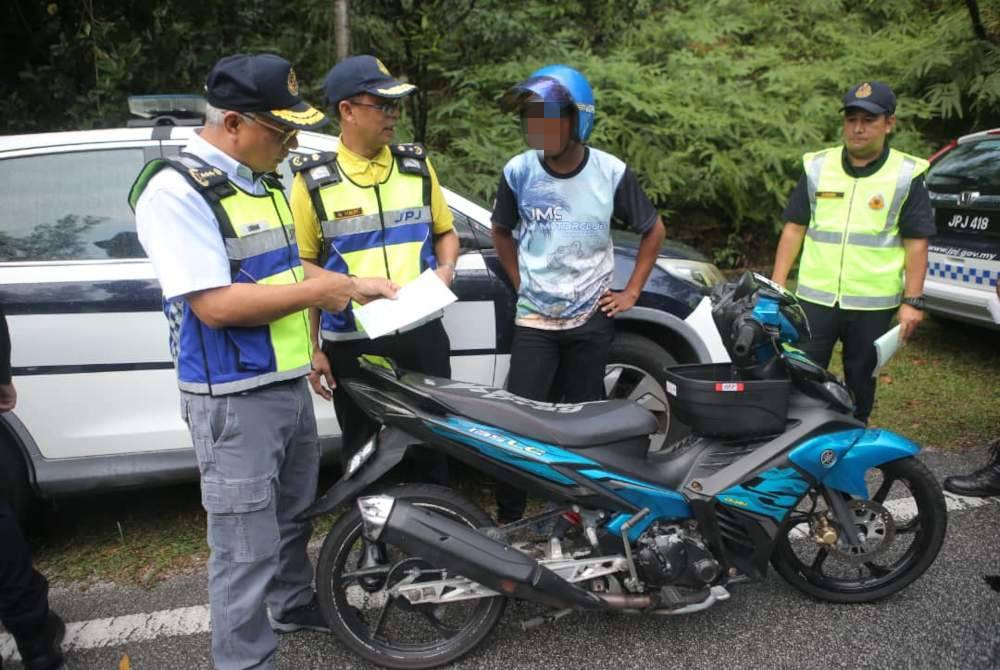 Lokman (kiri) turut memeriksa motosikal ketika Operasi Bersepadu Motosikal Hari Raya Aidilfitri Tahun 2024 di Bandar Meru Raya, di sini pada Ahad.