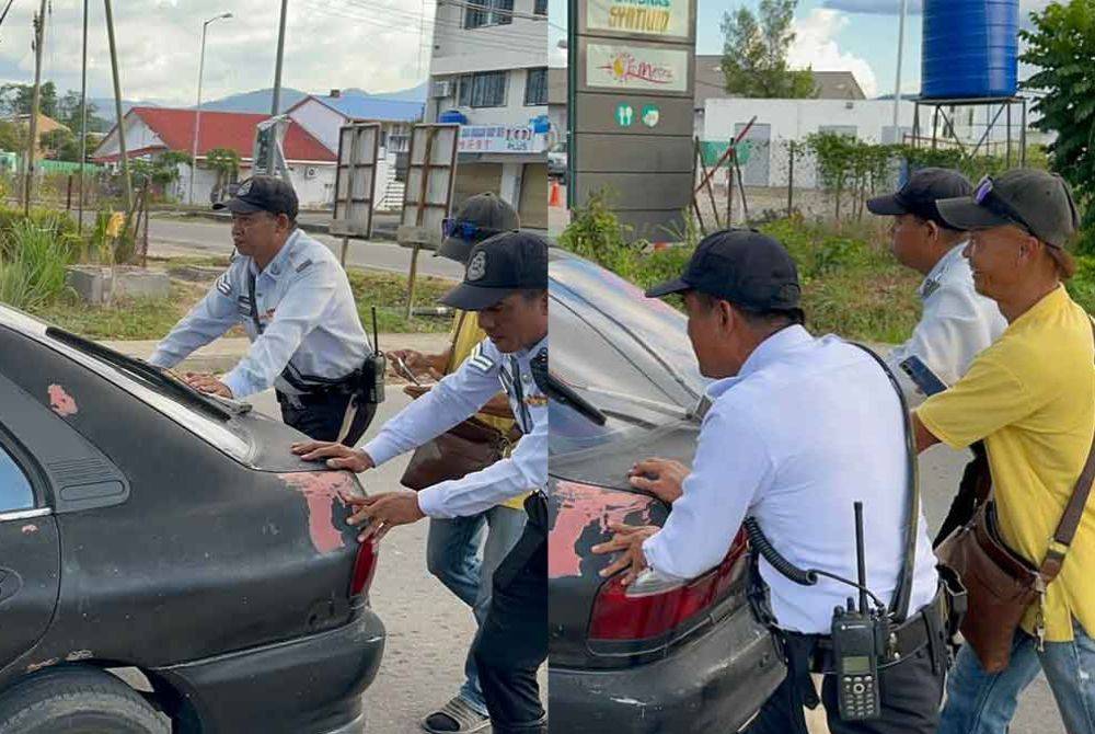 Mohd Najib (kanan) dan Nassir (kiri) membantu menolak kereta milik seorang OKU yang rosak di tengah jalan di Pekan Kota Marudu.