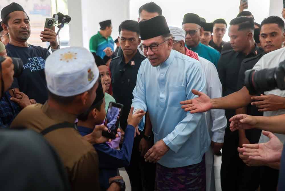 Anwar beramah mesra dengan jemaah yang hadir sebelum menunaikan solat Jumaat bersama rakyat di Masjid Bandar Teknologi Kajang hari ini. Foto Bernama