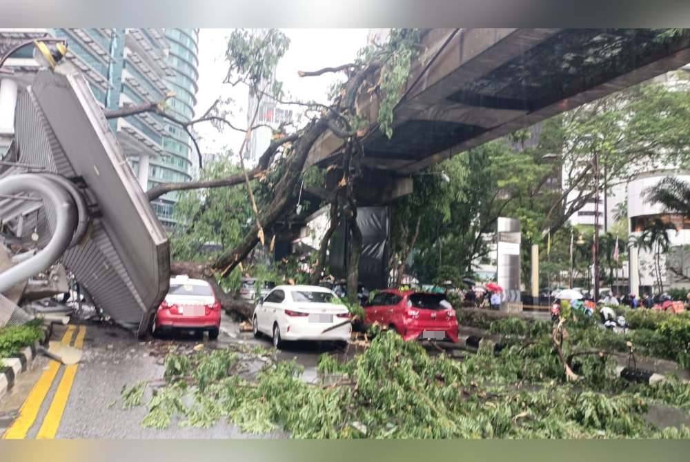 Sebatang pokok tumbang menghempap 17 kenderaan dan landasan monorel akibat hujan lebat serta angin kuat di Jalan Sultan Ismail, pada Selasa. Foto Facebook JBPM