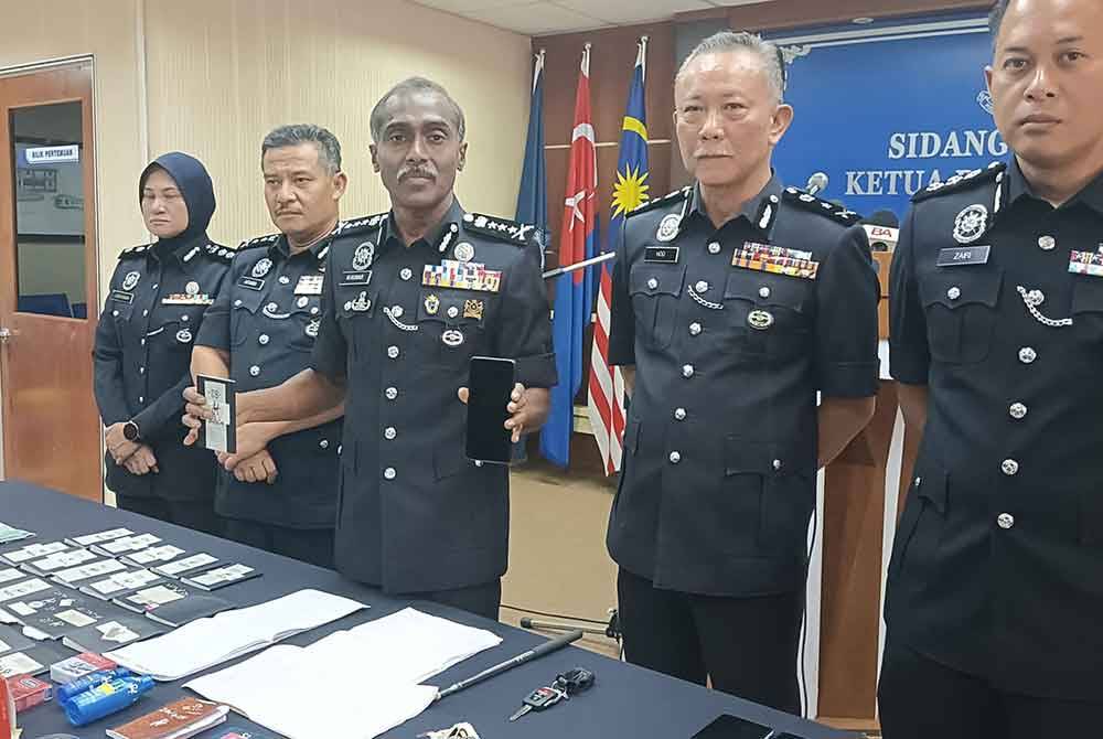 Kumar menunjukkan telefon bimbit yang digunakan Geng Bala dalam menjalankan kegiatan pelacuran selepas sidang akhbar di IPK Johor, Johor Bahru pada Selasa.