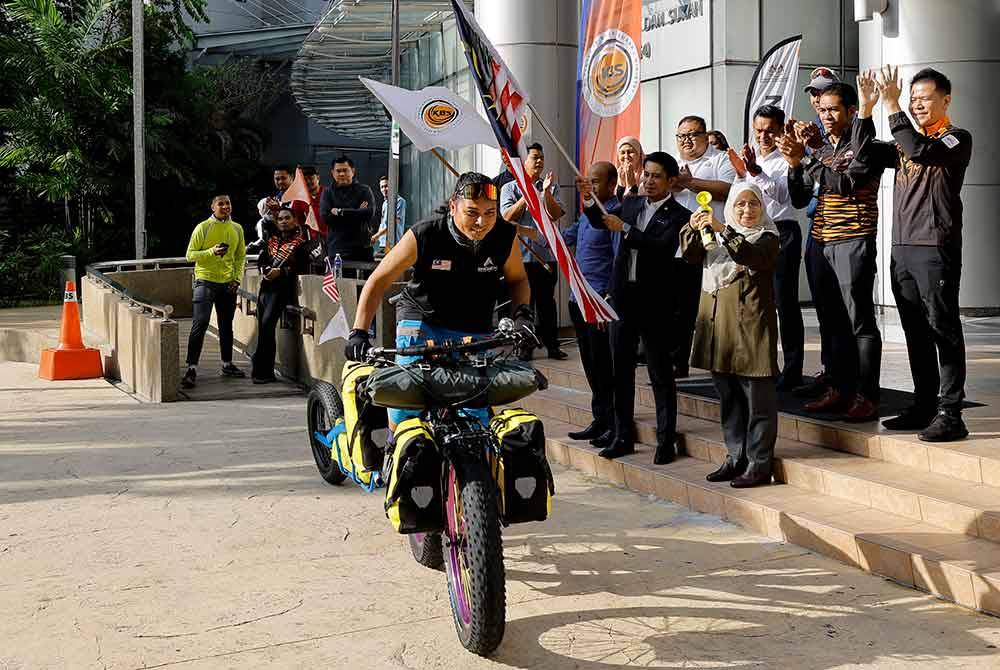 Adam Adli melepaskan Khairil Aslan bagi mengelilingi Semenanjung Malaysia untuk Latihan Pertama Ice Storm Russia Expedition 2025 di Kementerian Belia dan Sukan pada Rabu. Foto Bernama