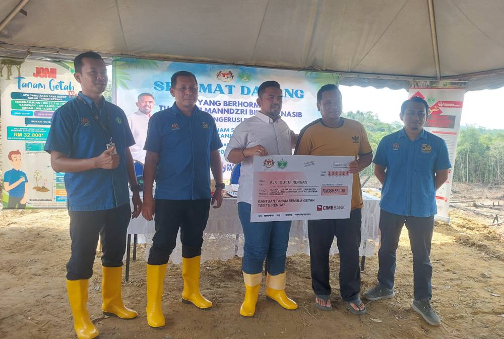  Manndzri (tengah) menyampaikan cek cura berjumlah lebih RM350,000 kepada salah seorang wakil peserta projek TSB Tanjung Rengas (dua dari kanan).