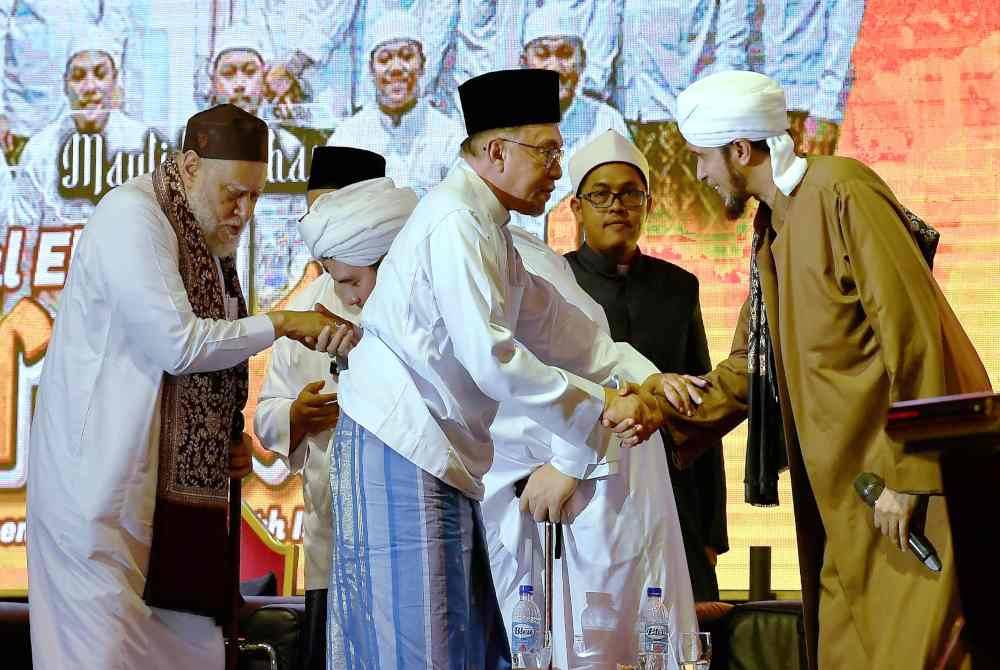 Anwar (tengah) bersama Bekas Mufti Agung Negara Mesir, Al-Imam Al-Allamah Prof De Ali Jum&#039;ah (kiri) pada Mawlid Akbar Darul Ehsan Berselawat di Dataran Tapak Karnival Pekarangan Stadium Shah Alam pada Ahad. Foto Bernama