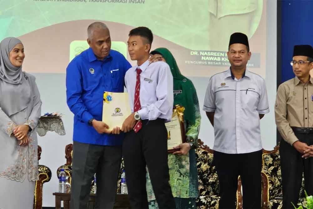 Khairudin (tengah) menyampaikan surat tawaran kepada salah seorang yang menyertai Program Hijrah Insaniah Yayasan Perak 2024 di Ipoh.