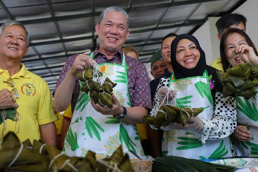 Fadillah (dua dari kiri) dan isteri Datin Seri Ruziah Mohd Tahir (dua dari kanan) membuat kuih chang atau Bak Chang pada program sambutan perayaan Duan Wu atau Dragon Boat Festival anjuran Biro Wanita Parti Rakyat Bersatu Sarawak (SUPP) pada Ahad. Foto Bernama