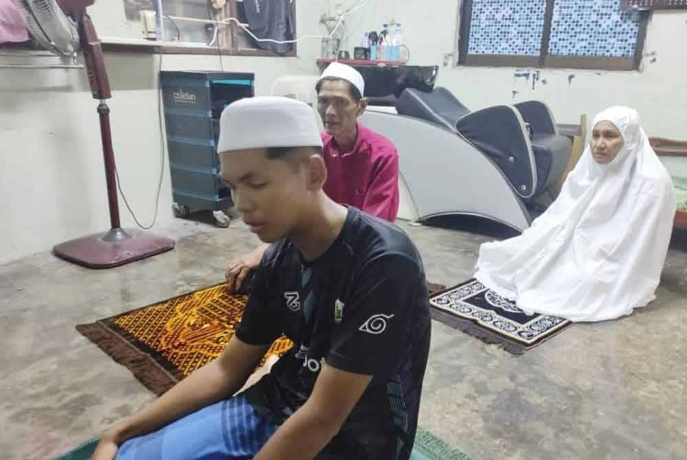 Firdaus Hong menjadi imam ketika solat berjemaah bersama ibu bapanya.