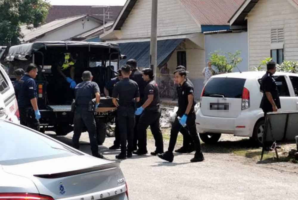 Anggota polis mengangkat mayat mangsa yang dipercayai dibunuh ketika berlaku pertengkaran di Kampung Simee, Ipoh pada Rabu.